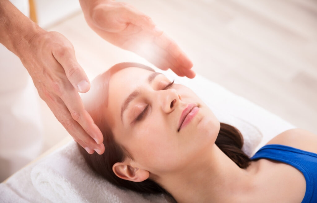 Reiki healing session with hands gently channeling healing energy.